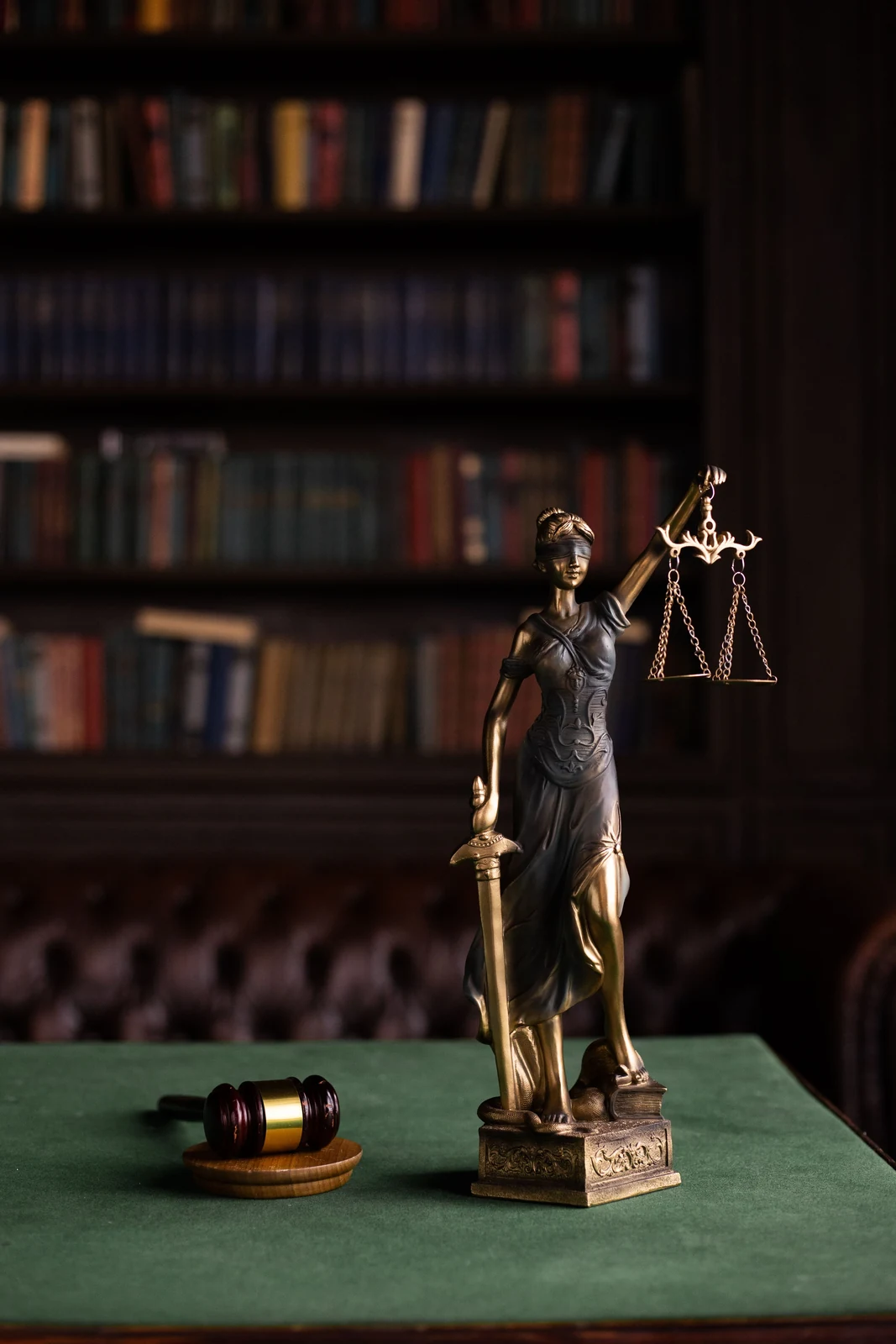 Bronze figure of Lady Justice beside a gavel